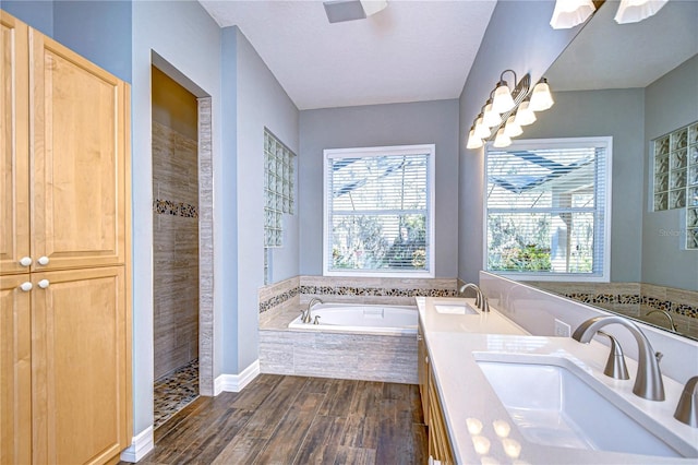 bathroom featuring hardwood / wood-style flooring, vanity, and independent shower and bath