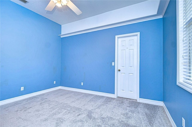 spare room with ceiling fan and carpet