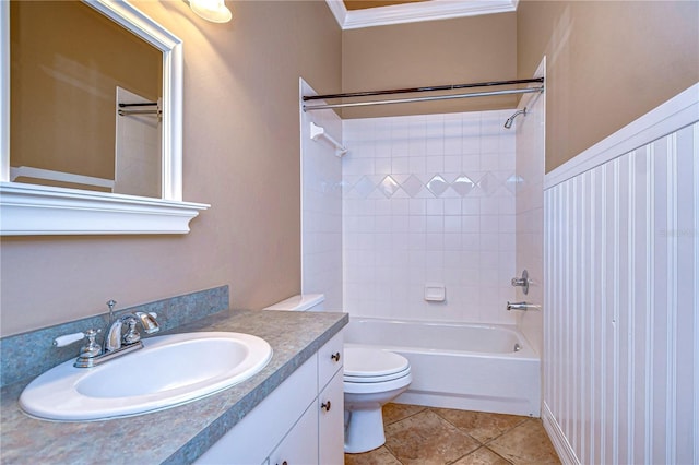 full bathroom featuring vanity, ornamental molding, tiled shower / bath, tile patterned floors, and toilet