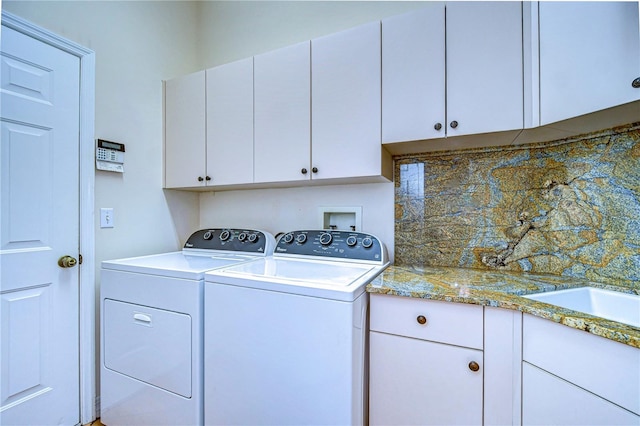 laundry area featuring cabinets and washing machine and clothes dryer