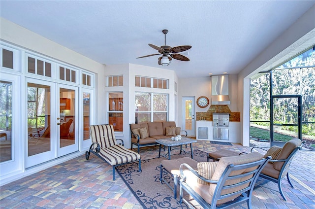 sunroom / solarium with french doors and ceiling fan