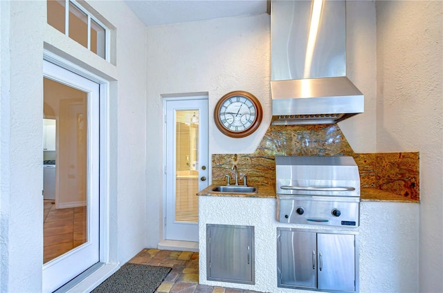 kitchen with sink and wall chimney range hood