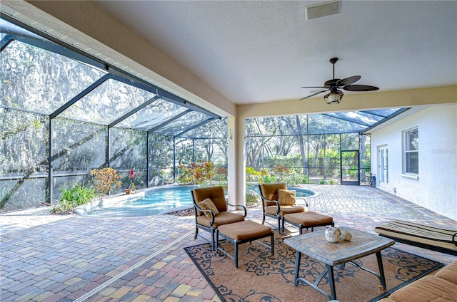 view of patio featuring a lanai and ceiling fan