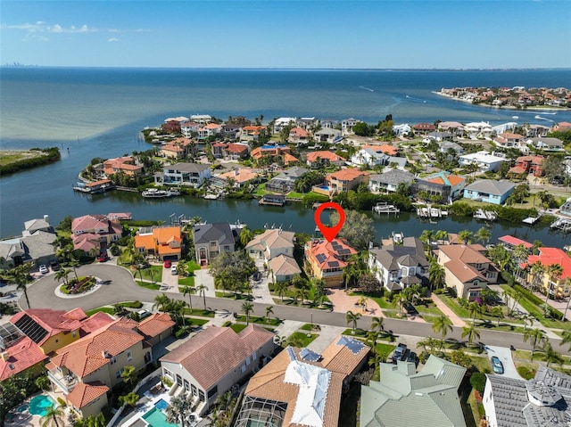 birds eye view of property with a water view and a residential view