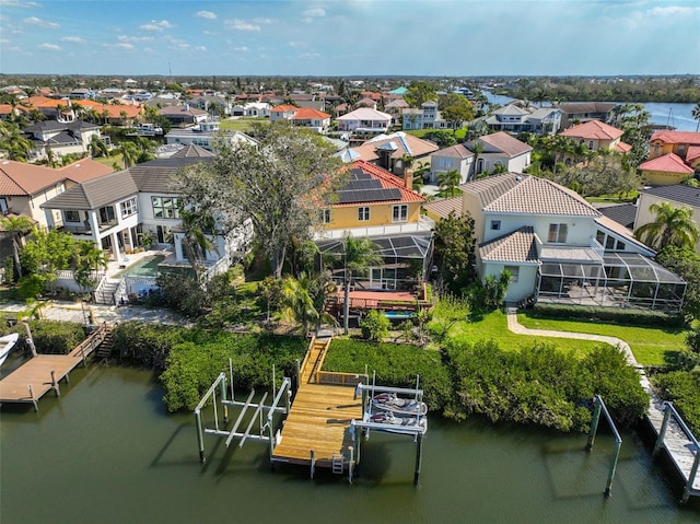 bird's eye view with a water view and a residential view