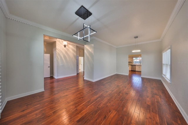 unfurnished room featuring ornamental molding, dark wood-style flooring, and baseboards