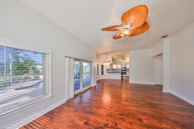 unfurnished living room featuring visible vents, dark wood-type flooring, ceiling fan, high vaulted ceiling, and baseboards