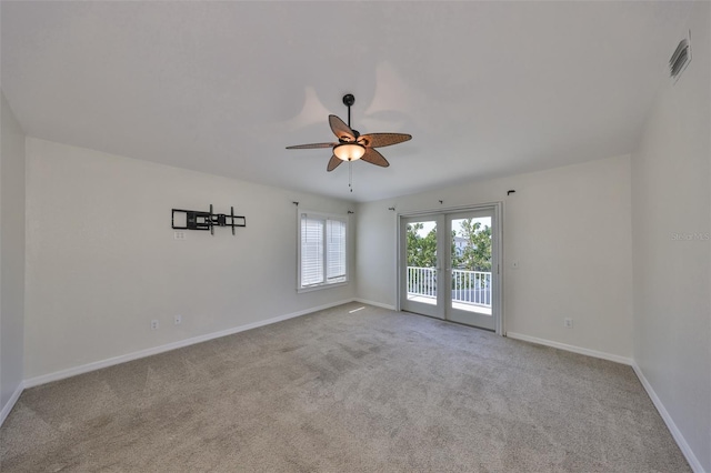 spare room featuring french doors, visible vents, carpet flooring, ceiling fan, and baseboards