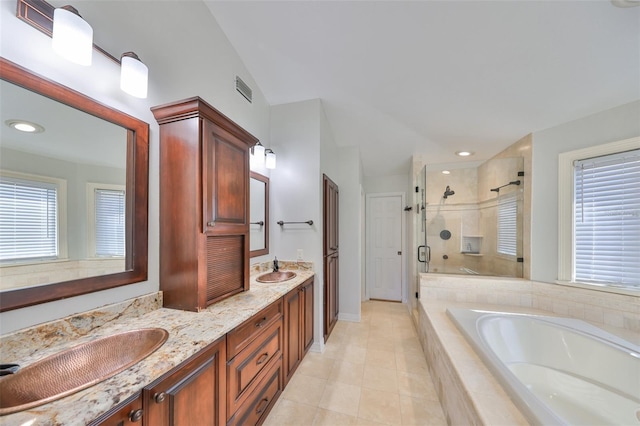 bathroom with a sink, a bath, double vanity, a stall shower, and plenty of natural light