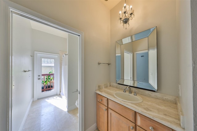 full bath with baseboards, vanity, toilet, and an inviting chandelier