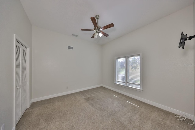 unfurnished bedroom with carpet floors, baseboards, and visible vents