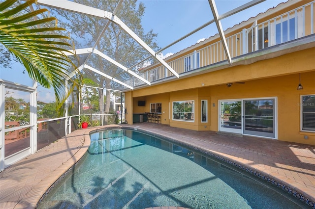 pool featuring a lanai and a patio