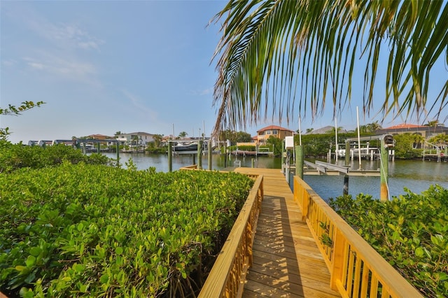 exterior space featuring a dock, a water view, and boat lift