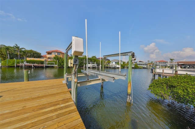 dock area with a water view and boat lift