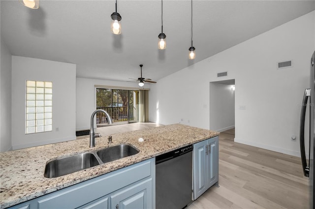 kitchen featuring sink, vaulted ceiling, light hardwood / wood-style flooring, dishwasher, and pendant lighting