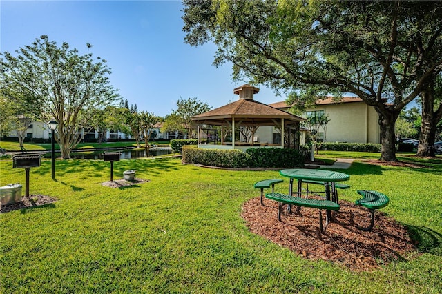 view of home's community featuring a gazebo, a water view, and a yard