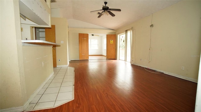 spare room featuring vaulted ceiling, ceiling fan, and light hardwood / wood-style flooring