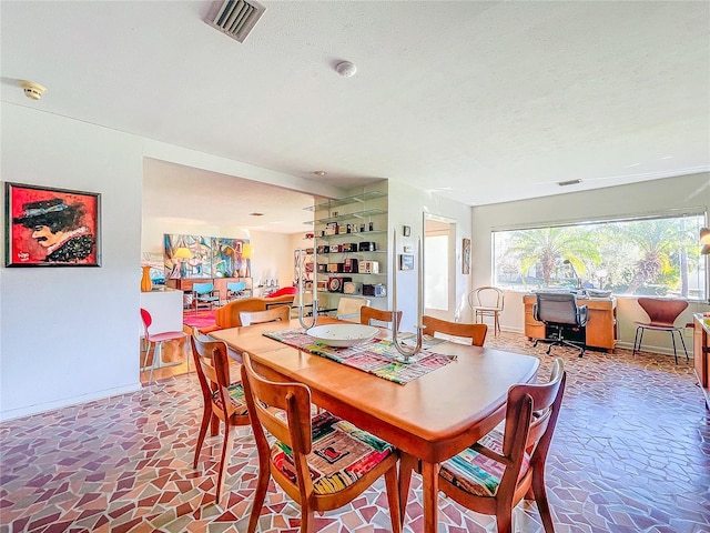 dining room with a textured ceiling