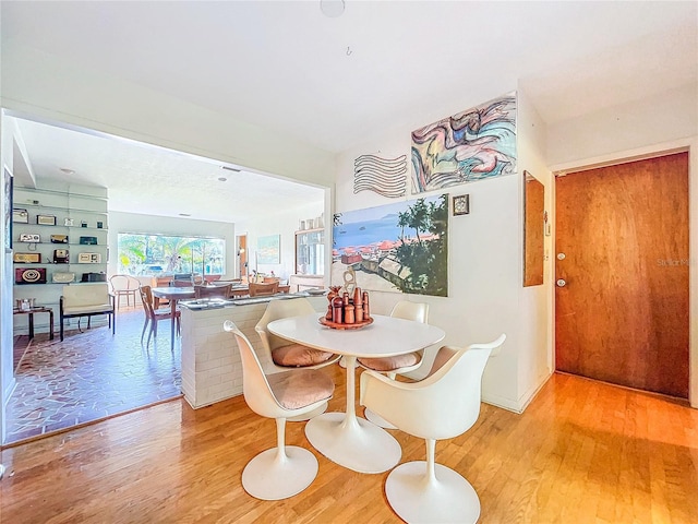 dining space with light hardwood / wood-style flooring