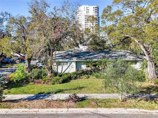 view of side of home with a yard