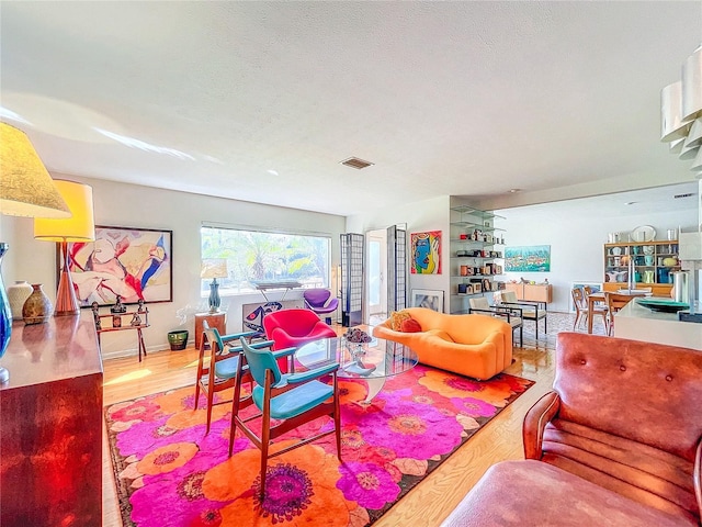 living room with hardwood / wood-style flooring and a textured ceiling