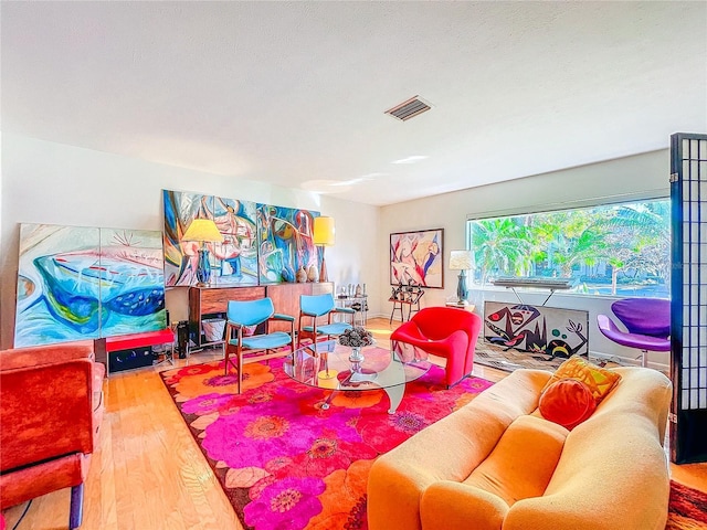 living room featuring wood-type flooring and a textured ceiling