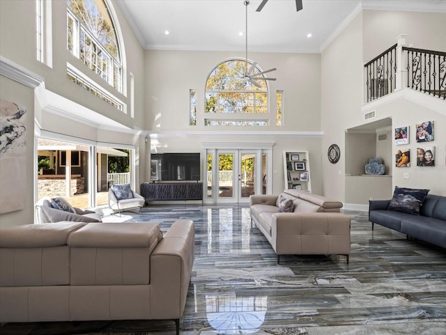 living room with crown molding, plenty of natural light, ceiling fan, and french doors