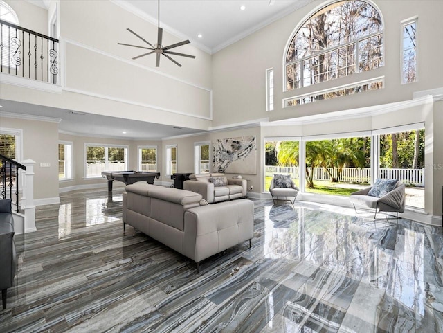 living room with a high ceiling, ornamental molding, and pool table