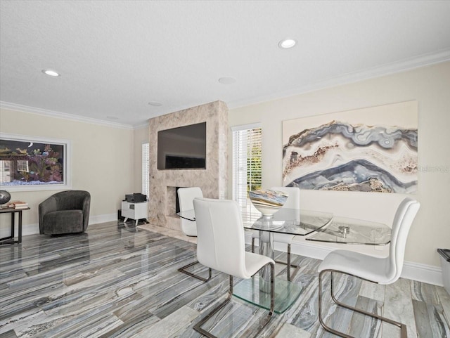 dining room with crown molding, a large fireplace, and a textured ceiling