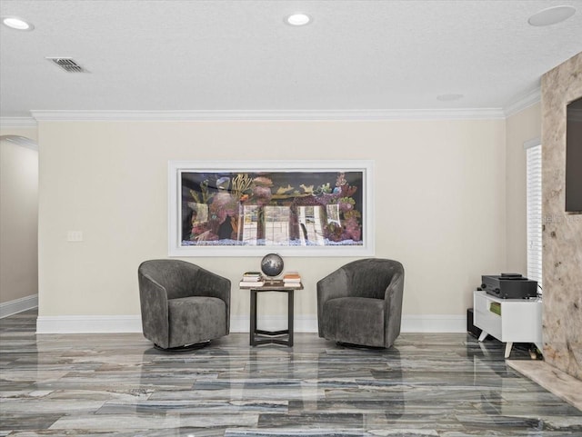 living area featuring crown molding and a textured ceiling