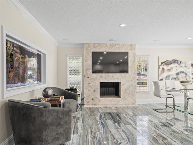 living room featuring crown molding, a premium fireplace, and a textured ceiling