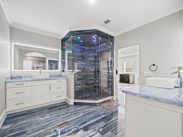 bathroom with crown molding, vanity, and an enclosed shower