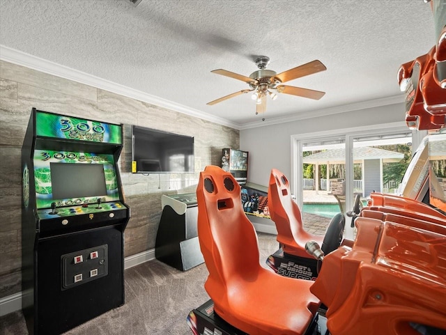 playroom featuring carpet floors, ornamental molding, and a textured ceiling