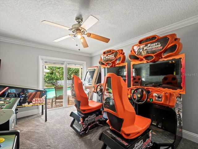 rec room with ceiling fan, ornamental molding, a textured ceiling, and carpet