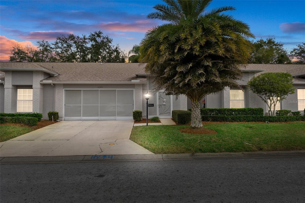 view of front facade with a yard and a garage