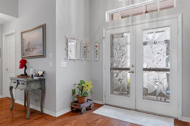 foyer entrance with french doors and hardwood / wood-style flooring