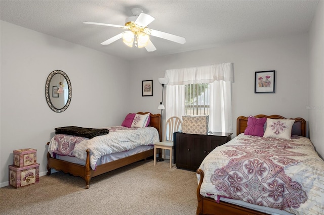 bedroom with ceiling fan, light colored carpet, and a textured ceiling