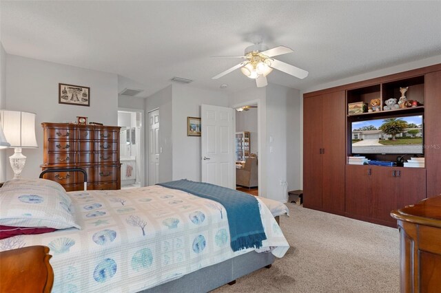 bedroom with ensuite bath, ceiling fan, and carpet flooring