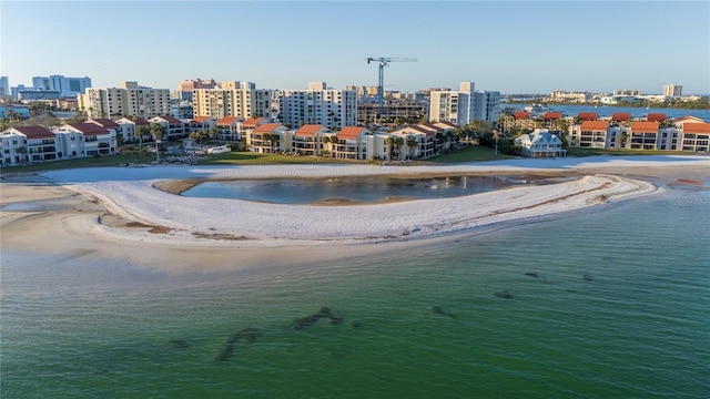 bird's eye view featuring a view of the beach and a water view