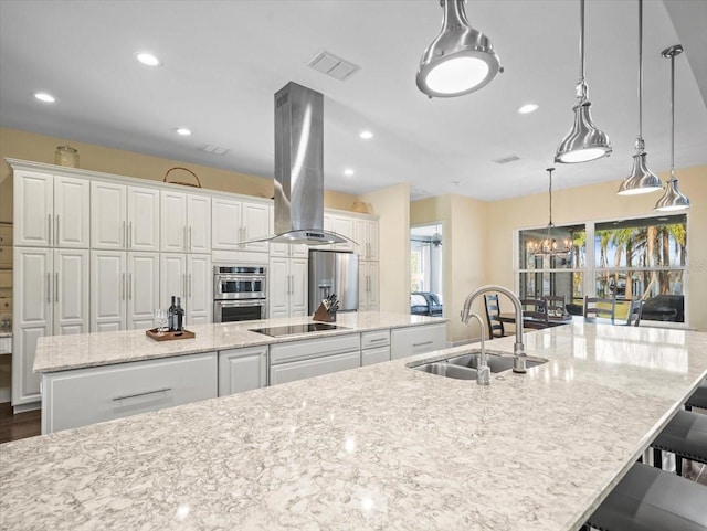 kitchen with island range hood, sink, white cabinets, hanging light fixtures, and a spacious island