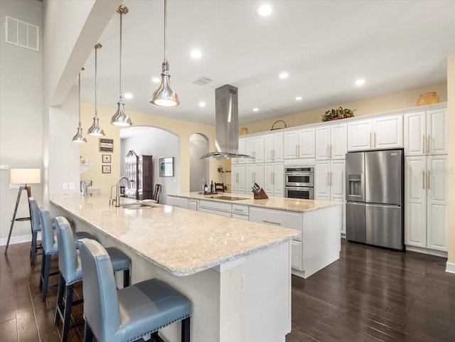 kitchen featuring sink, stainless steel appliances, white cabinets, island exhaust hood, and kitchen peninsula