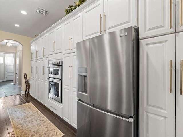 kitchen with white cabinetry, dark wood-type flooring, and stainless steel appliances