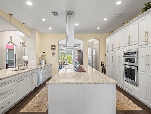 kitchen featuring sink, appliances with stainless steel finishes, dark hardwood / wood-style floors, light stone countertops, and white cabinets