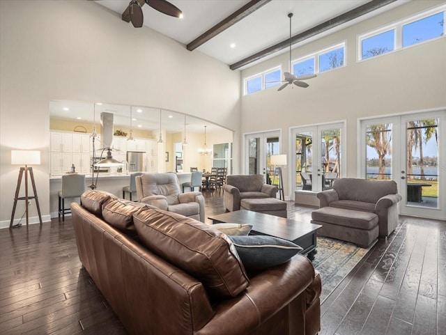 living room with dark hardwood / wood-style flooring, beam ceiling, french doors, and ceiling fan