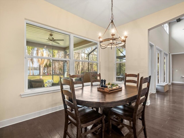 dining area with dark wood-type flooring and ceiling fan with notable chandelier