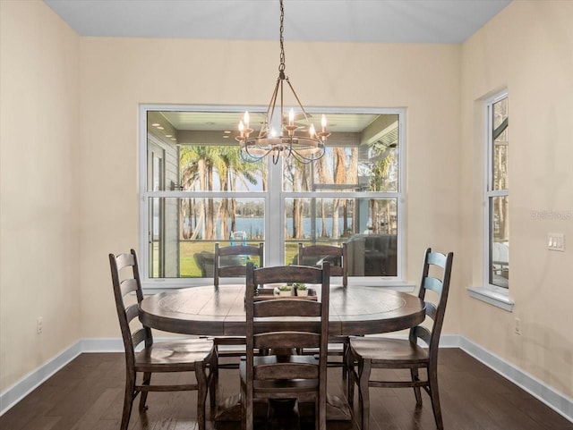 dining room featuring dark hardwood / wood-style floors and a chandelier