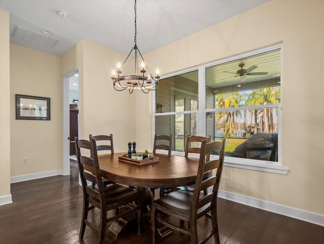 dining room with ceiling fan with notable chandelier and dark hardwood / wood-style flooring