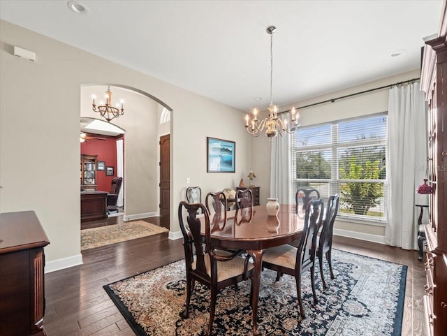 dining space with an inviting chandelier and dark wood-type flooring