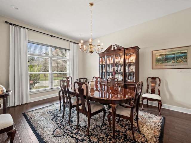 dining area featuring dark hardwood / wood-style floors and a chandelier