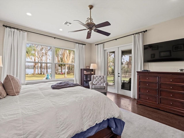 bedroom featuring access to exterior, dark wood-type flooring, french doors, and ceiling fan